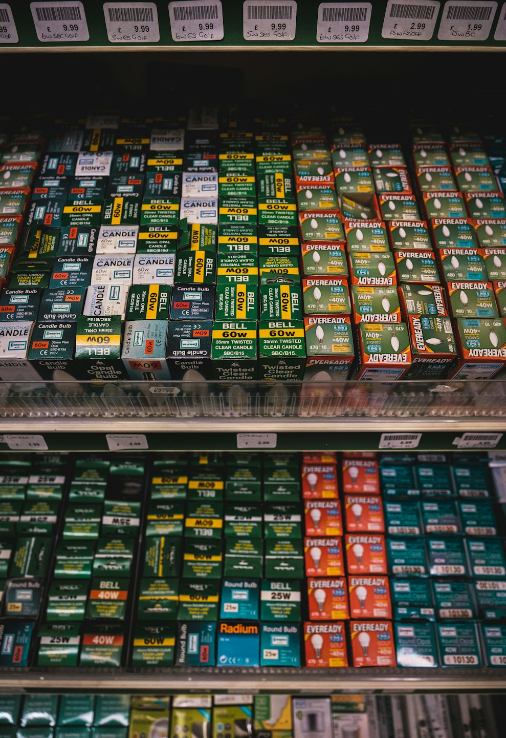 Retail shelves stocked with many boxes of light bulbs.